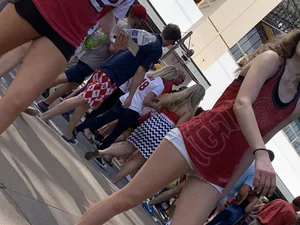 Bunch of girls in various outfits at a Cardinals baseball game
