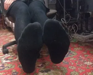 College girl's feet in black pantyhose closeup