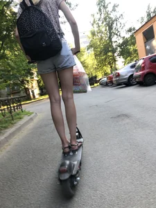 Skinny Candid Girl in Denim Shorts on a Scooter Suburban Street Creepshots