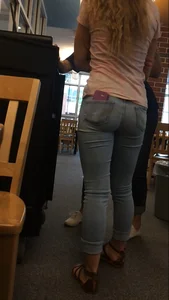 Very cute teen candid girl wearing tight jeans with a phone in back pocket