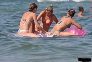 A bunch of sexy beach voyeur babes in bikinis, thongs and topless