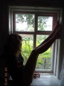 Young And Skinny Barefoot Girl in Panties Sitting on the Windowsill of a Country House