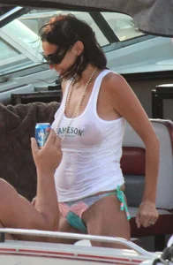 Bikini babe on a boat with a wet see through white shirt showing her tits