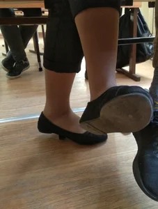 Candid Teen's Feet in Pantyhose And Flats Under Table Closeup