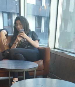 Skinny Girl in Leggings Sitting With Crossed Legs in an Armchair Creepshot