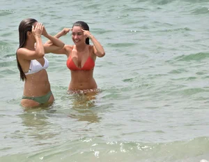Two sexy ass girls on the beach in bikinis