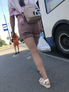 Young Girl in Sandals and Shorts in a Public Bus