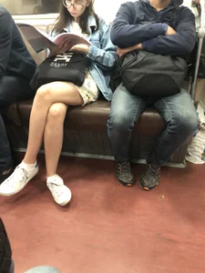 Girl in Glasses Reading a Magazine in a Subway Train - Hot Crossed Legs