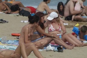 Topless girls on a beach in Barcelona