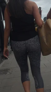 Sexy girl walking in grey patterned leggings with friend in tight jeans