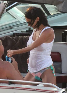 Bikini babe on a boat with a wet see through white shirt showing her tits