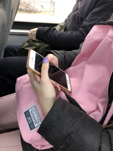 Cute teen girl's manicured hands holding a phone in a public bus creepshots