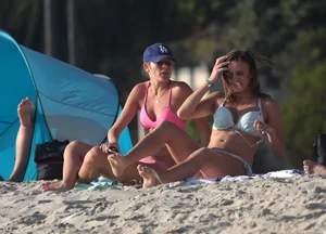 Two sexy friends out on the beach in bikinis