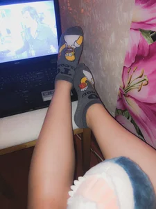 Feet in Simpsons Socks on Table Selfie
