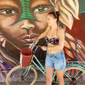 Cute candid bike girl in jean shorts and a swimsuit top
