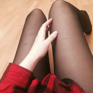 Girl in Checkered Shirt and Black Pantyhose Sitting on the Floor Touching Her Leg Home Selfie