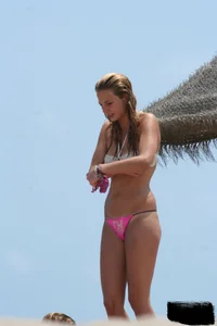 Hot beach girl undressing and going topless