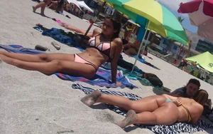 2 beach friends in bikinis,one thick and in a thong