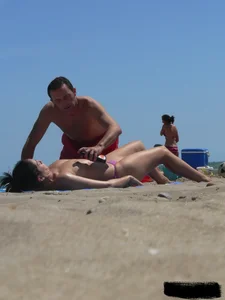Purple thong topless lady on the beach gets oiled up by her husband