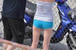 Skinny babe with a cute little ass in tiny blue shorts