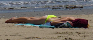 Sexy ass blonde milf on the beach in a thong with cameltoe and bending over