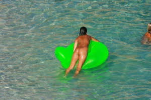 FKK Nudists playing in the water with floater