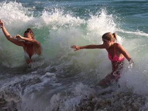 Sexy beach girl in bikini with her other sexy friend
