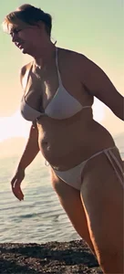 Chubby mature in a swimsuit wet after a swim