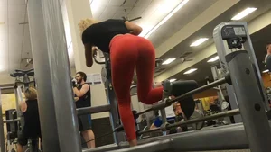 Very hot and sexy blonde at the gym working out in red leggings