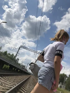 Cute Girl in Denim Shorts Walking Down a Railway Station Gallery