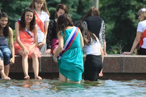 Young College Girls in Dresses, Skirts And Pantyhose Having a Good Time By the City Fountain