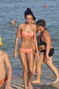 Sexy brunette in peach bikini with incredible body