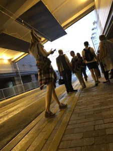 Cute Teen in Shorts on the Tram Stop