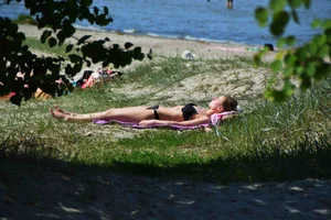 Skinny Girl in Swimsuit on Beach Candid Photo