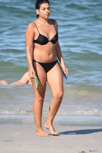 Thick mature brunette bikini lady on the beach with a nice body