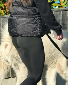 Pouting brunette teen in black leggings