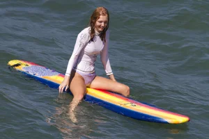 Wet surfer girl in slightly transparent clothes