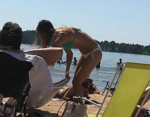 Swedish beach blonde girl in white and green bikini