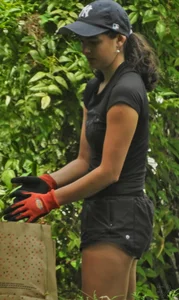 Brunette gardener in shorts bends over… and over as she works [085]