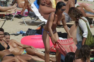 Topless girls on a beach in Barcelona