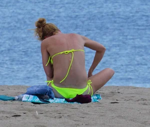 Sexy ass blonde milf on the beach in a thong with cameltoe and bending over