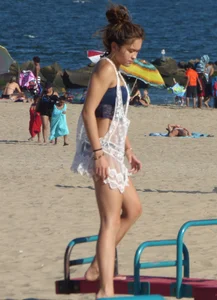 Beach teen in semi thong bikini under see through dress on the beach