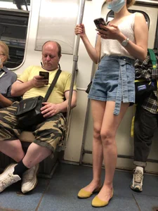 Girl in Blue Denim Shorts and Flats Standing in Subway Train - Nice Legs Closeup