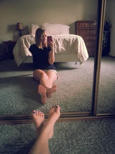 Girl With Bare Feet in Shorts Sitting on the Floor Mirror Selfie in Bedroom