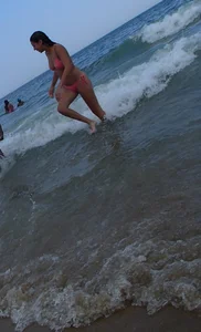 Pierced nipples hottie in pink at the beach