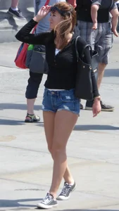Cute girl with nice legs in short denim shorts