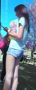 Skinny girl with purple hair in denim shorts