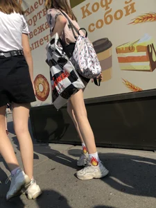 Couple of Skinny Girls in Mini-Skirts And Sneakers Street Photos