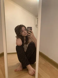 Hot Barefoot Girl Sitting on the Floor With Crossed Legs Mirror Selfie
