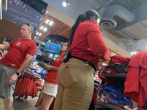 Bunch of girls in various outfits at a Cardinals baseball game